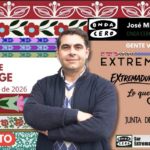 A man with folded arms stands in front of a colorful promotional poster for an event on July 23, 2026.